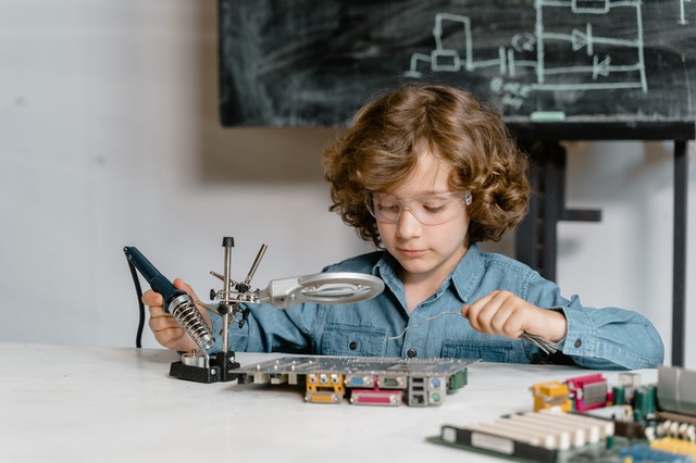 Kid experimenting with circuit board